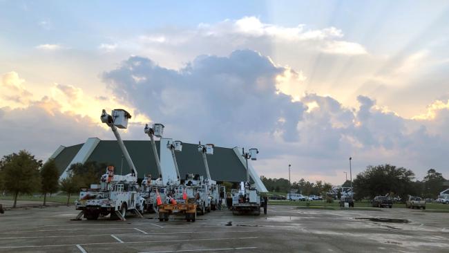 The sun shines behind clouds overlooking the University Center and bucket trucks at Southeastern in Hammond, Louisiana The sun shines behind clouds overlooking the University Center and bucket trucks at Southeastern in Hammond, Louisiana