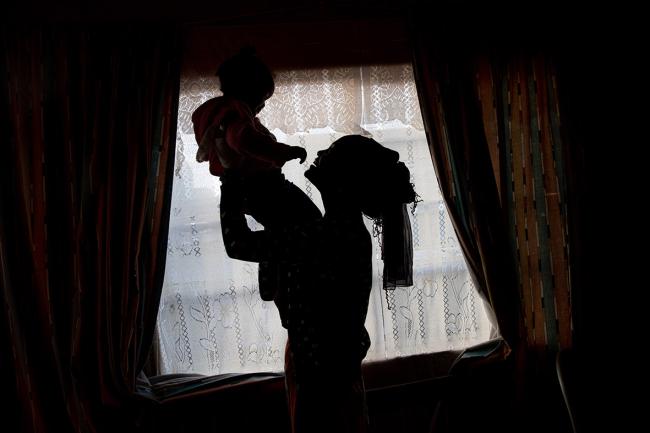 Silhouette of mother holding baby