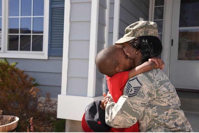 Photo credit: Operation Homefront Soldier hugging son in front of house