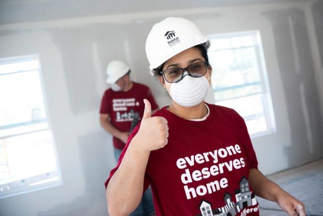 Two volunteers building a home with Habitat for Humanity
