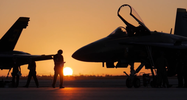 a pilot and a boeing in front of a sunset 