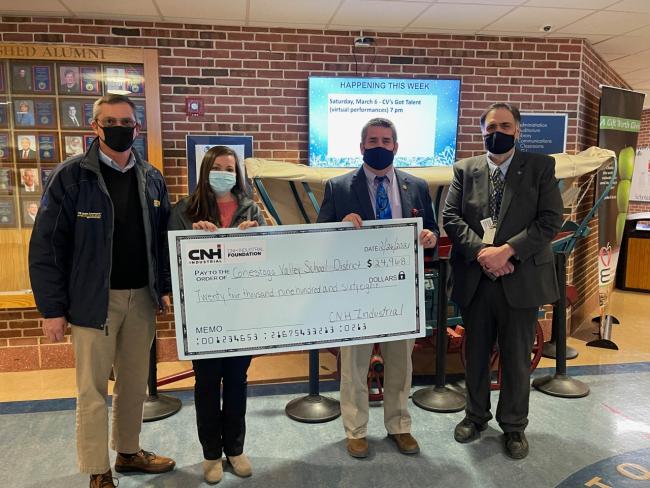 The CNH Industrial team in New Holland, PA, presents the check to the Conestoga Valley High School.