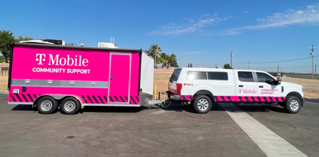 TMobile community support truck and pink trailer on the road