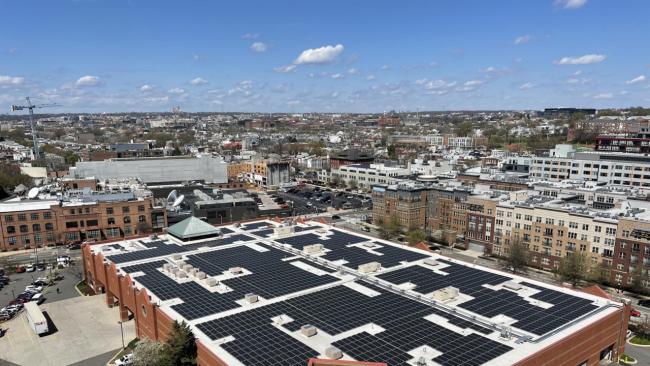 aerial view of rooftop solar installation in a city landscape