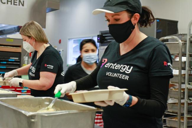 volunteers in masks serving food