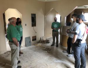 team of volunteers in a damaged home