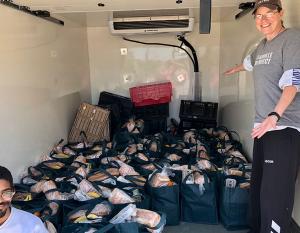 Volunteers deliver grocery bags filled with dairy, produce and bread for hospitality workers who lost income during the pandemic.