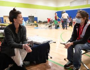 two people talk in a Red Cross shelter