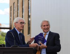 Wisconsin Governor Tony Evers, left, presents Beloit College President Scott Bierman with a state energy efficiency award during a ceremony on Wednesday commemorating the Beloit College Powerhouse redevelopment project.