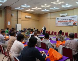 Person speaking at an event with people sitting at tables