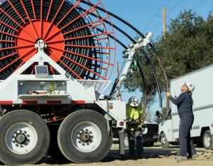 Vasquez works on a puller machine preparing to route underground electrical cables for a residential development. Vasquez works on a puller machine preparing to route underground electrical cables for a residential development.