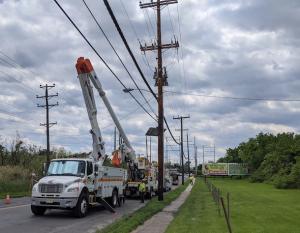 Photo showing PSEG crews updating power lines. Cherry picker truck is next to a telephone pole.