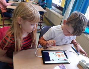 Students practice lessons through a tablet game. Photo Courtesy of DeBroeBELschool.