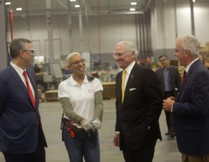 Danica Armstrong, Trane Columbia production leader, discusses operations at the recently expanded facility, with Donny Simmons, president, Trane Commercial HVAC North America and EMEA (far left), Governor Henry McMaster (middle), and Trane Columbia Plant Manager Gregg Krick (far right).