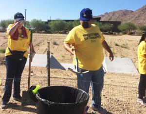 Edison volunteers clear brush and debris along the tribe’s desert tortoise exclusion fence. Credit: Susan Cox