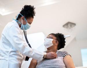 doctor using stethoscope on patient