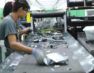 At the Sinctronics recycling facility, employees deconstruct equipment and sort parts with help from sensors that can distinguish between types of plastic that look identical to human eyes.