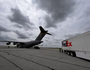 Military plane and FedEx truck