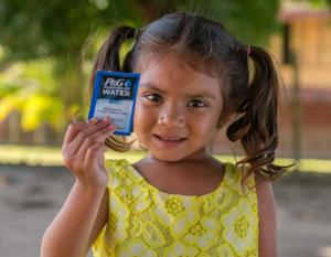 girl holding P&G water packet