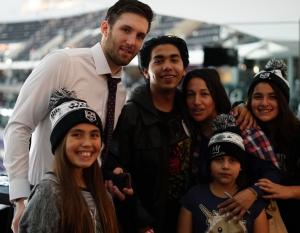 LA Kings defenseman Derek Forbort welcomes families and poses for pictures at the LA Kings Adopt-A-Family event at STAPLES Center on December 9, 2017.