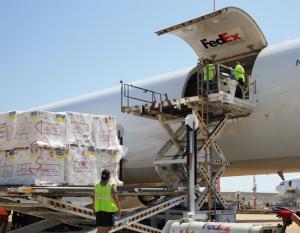 Medical supplies being loaded into a FedEx plane