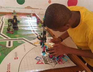FIRST® Lego League student in Nigeria prepares his robot for competition