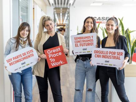 4 people holding signs celebrating Great Place to Work certification