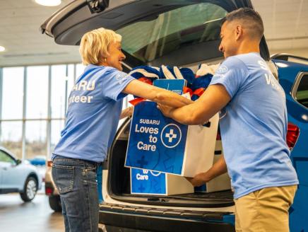 Subaru employees loading supplies into car