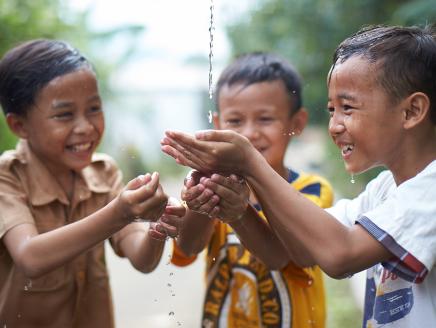 Children catching water in their hands