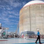 Nicole Flippin walking around outside structures at the power plant