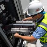 person working on electrical equipment