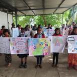 a group of school children holding handmade posters