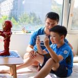 child and parent using a robot through a mobile device