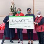 4 women holding large check