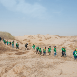 Timberland volunteers hiked back through the desert after planting 650 trees in celebration of Earth Day, Since 2001, Timberland has partnered with Green Network to plant trees in the desert to minimize sandstorms, improve air quality, and stop the spread of the desert.