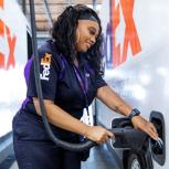FedEx employee charging an electric vehicle 