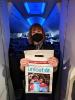 Flight attendant holds up a UNICEF donation bag