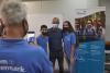 Pep Guardiola poses for a picture with two people wearing Xylem shirts