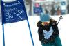 Person skiing next to a "celebrity ski" banner