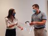 Aflac Benefits Coordinator Clare Mione delivers one of 1,000 face shields provided to Julian Hagmann, vice president of Caring Professionals, as part of Aflac’s $2 million donation to the Global Center for Medical Innovation, which manufactured the shields. The New York State Association of Health Care Providers helped identify organizations of frontline workers for the delivery of 80,000 of these shields in New York State. Image courtesy New York State Association of Health Care Providers website