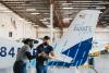 two people working in an airline hangar