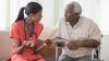 Female black doctor consulting with a male, black patient.