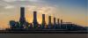 Smoke stacks in the skyline at sunset