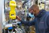 Worker at Rockwell Automation guiding machine
