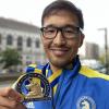 Phil Shin proudly displays his medal for completing the 2021 Boston Marathon.