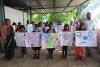 a group of school children holding handmade posters