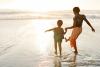 mother and child wading at the beach