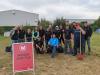 Employees gathered together by Winzer Shuttle sign