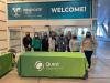 People standing by Quest Diagnostics table at conference 