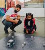 Two people looking at robot navigating blocks